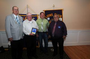 Lloyds Market in Lewes was presented an Appreciation Award for its assistance in preparing 50 food baskets for the Lions Club's Christmas food deliveries. Shown are (l-r) King Lion Pete Dirks, Lloyd Purcell, Lenny Pollitte and George Russ.