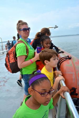 Students Kelis Gibbs, front, Keller Mancari and Nevaeh Copes with first-grade teacher Katie Freer keep vigil on the upper deck of Thelma Dale V. BY RON MACARTHUR