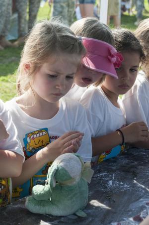 Lily Noonan, Violet Reichert, and Avary Miller from Sheilds Elementary listen to stories about bacteria. BY DENY HOWETH