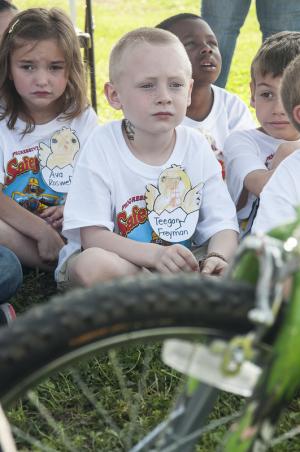 Ava Roswell, Teegan Freeman and Isaiah Blackwelllisten to Jr. ROTC members discuss bike safety. BY DENY HOWETH