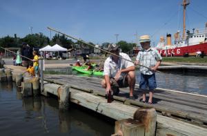 Landon, right, and his dad Mark Cieniewicz of Lewes patiently wait for the big one. BY STEVEN BILLUPS