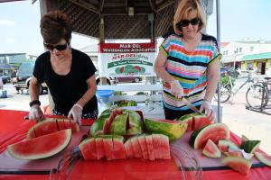 Making sure the queens are loaded with plenty of slices are Eleanor Bullock of the National Watermelon Association, left, and Ann Bryant of the South Carolina Association. BY DAN COOK