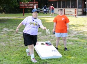 Beth Ann Lints, left, throws the bag in a game of bean bag toss while opponent Leanna Evans looks on. BY DAN COOK