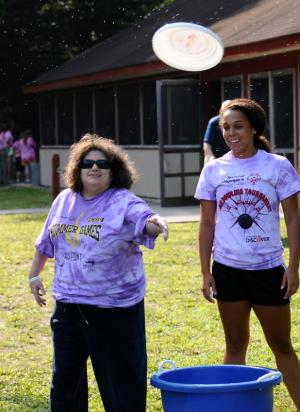 SODE athlete Beth Anne Fuhs, left, tosses the Frisbee during a game of Can Jam with her counselor/partner Marissa Robinson. BY DAN COOK