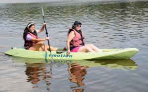 SODE volunteer Kate Goorland, left, paddles athlete Tina Hollis on Millers Creek during the kayak activity. BY DAN COOK