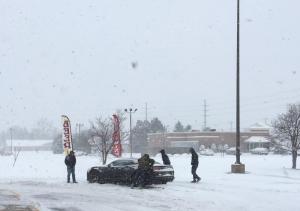 An unlucky driver ran into some bad luck at the entrance of Pelican Square shopping center at Midway. Luckily he gets some help from his friends. CHRIS RAUSCH PHOTO