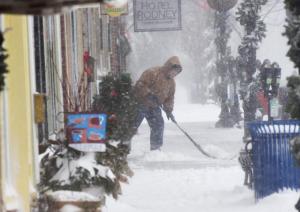 Former Mayor Jim Ford clears snow from the sidewalk in front of Kids’ Ketch on Second Street in Lewes. NICK ROTH PHOTO