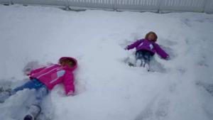 Karly Larsen and Jaiden Buchanan making snow angels in Milton. JULIE LARSEN PHOTO