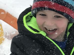 Alex Mavity, 5, enjoys throwing snow in the air near Lewes. RACHEL SWICK MAVITY PHOTO
