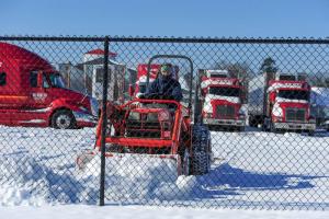 A Reed Trucking Company employee clears the parking lot for the big rigs. DAN COOK PHOTO