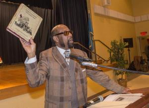 Bishop Roland Mifflin from Power and Love Outreach Ministry in Dagsboro holds up a copy of "From Crossroads to County Seat” from the Georgetown Historical Society. Mifflin said: "This book shares some of the things we used to go through; they used to have a whipping post in Georgetown; they hanged people in Georgetown; these are the things we were part of. We couldn't go and sit down like everybody else, but because of a grand family, we were told a good name is better than riches." He talked about the community that surrounded all the children who attended the school.