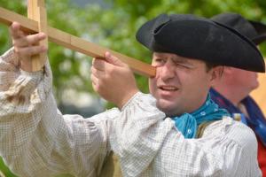 Kyle Dalton of Annapolis, Md., demonstrates how a cross-staff is used for navigation. The instrument dates back to the 16th century. RON MACARTHUR PHOTO