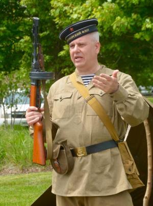 Soviet naval infantryman James Koury demonstrates a weapon used by the Russians during World War II. RON MACARTHUR PHOTO