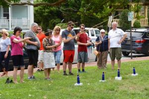 Visitors to Zwaanendael Museum’s Maritime Celebration try their hand at the traditional bottle game. RON MACARTHUR PHOTO