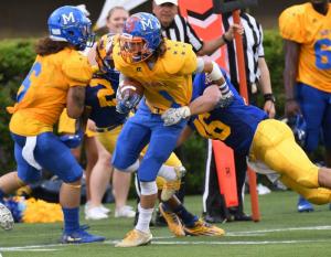 Delmar wide receiver Jimmy Adkins pulls in a Nolan Henderson pass and drags Blue linebacker Andrew Jaworski to a Gold first down. DAN COOK PHOTO