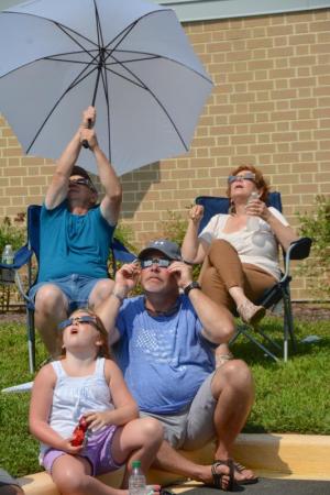 Like millions of others across the country, viewers at Lewes library look toward the sun. RON MACARTHUR PHOTO
