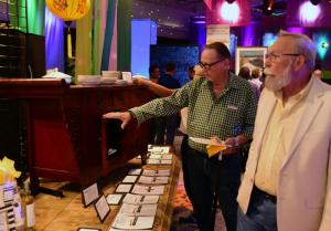 Tom Carlson, left, and Ray Michner of Milton examine a sideboard cabinet donated by Bob Gingrich and Eleanor Kiesel.