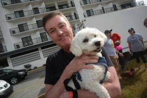 Neil Frock holds his dog Ashton at the event. Ashton was rescued from the Georgetown Campus of the Brandywine SPCA. Bark on the Boards