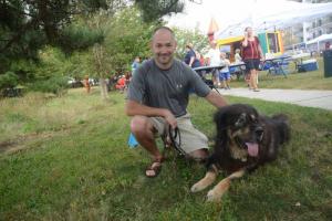 Resting in the shade is Hoss, a 12-year-old rescue dog. Shown with Hoss is his owner, Hunter Whitman Bark on the Boards