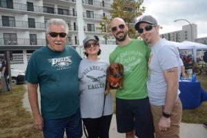 Susie, center, gets plenty of attention from (l-r) Fred and Anna Cusick, Brian Collins and Fred Cusick Jr. Bark on the Boards
