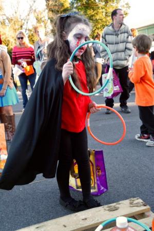 Sarah Roseman of Lewes – dressed as a vampire – takes aim in a ring-toss game at Sussex Family YMCA. RON MACARTHUR PHOTO