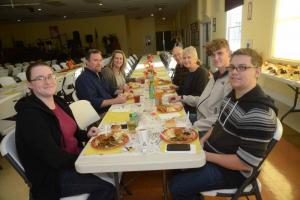 Getting first dibs on the Thanksgiving meal are (l-r) Holly Pereira, the Rev. Dr. Bill Davis, Susan Davis, Fred and Carol Daieileson, James Davis and Joshua Pereira. Conley’s Thanksgiving