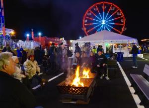 On opening night, people gather around a fire at the ferry terminal. RON MACARTHUR PHOTO