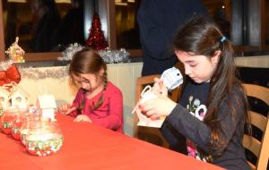 Sophia Fowler, 7, of Milton, right, and her sister Josalyn Fowler decorate little houses with candy. NICK ROTH PHOTO