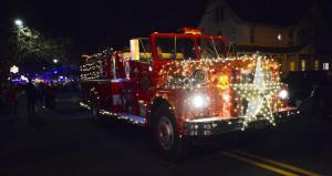 Mark Droney of Millville drives his Outlaw Fire Department 1970 Maxim fire truck, a first-place winner in the decorated-vehicle division.