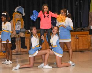 HOB student Erin Lynch performs a stunt with cheerleaders Shauna Brittingham, left, and Haley Schnupp.