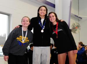 Aya Daisey stands on the first-place podium after winning the 100 butterfly with a 1:02.34. Taking second place was Amy Venables, right, from Sussex Tech, and Caesar Rodney’s Alex May finished third.