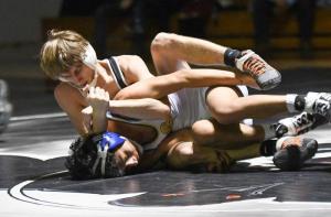 Tech’s Hunter Hineline, top, goes for a power half with Central’s Yony Morales at the 120 class. Morales won a 3-0 decision.