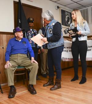 A Hero’s Welcome Director Rosely Robinson reads Bayard Horn’s story and begins the presentation. Rebecca Bristow, right, met Horn, left, on the Rehoboth Boardwalk and started the process for the ceremony.
