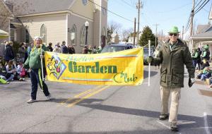 Rosanna Zinner and Doug Welch carry the Milton Garden Club banner.
