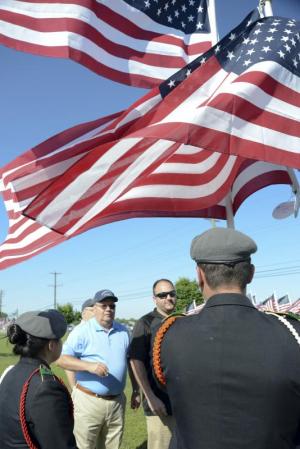 Dave and Dan Tidwell, not shown is Jason Bently present the flag for Del Tech Veterans Center. Escorts where Davi Marins and Almita Ramirez Montana.
