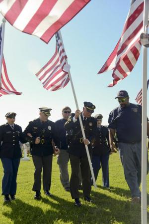 Police, firefighters and first responders were honored by Lewes and Rehoboth police and fire chiefs at the Flags for Heroes ceremony. Shown (l-r) are escort Sabrinna Bennett; Lewes Police Chief Thomas Spell; Rehoboth Beach Fire Chief Chuck Snyder; Rehoboth Beach Police Chief Keith Banks; escort Samantha Holt and Michael Rickards.