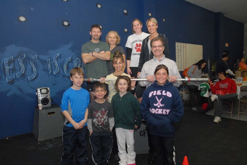 CrossFit Lewes hosted a health and fitness even during its April 9 grand opening. Emphasizing functional movements in varied settings, CrossFit trains individuals from 6 to 86 in 20-minute sessions. Shown at the CrossFit bar lift opening in back are (l-r) Dion Lamb, trainer; Liz Roc, kids' trainer; Katie Lyell, kids' trainer; and Kris Carper, lead trainer. In the middle are Meredith Simmons, owner/trainer; and Lewes Mayor Jim Ford. In front are CrossFit Kids Hunter Simmons, Nick Ruggio, Charlie Simmons and Sophie Ruggio. SOURCE STEVEN BILLUPS PHOTO