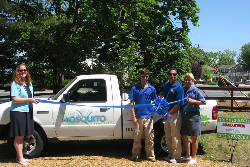 Shown are (l-r) Meghan McCalley, Rehoboth Beach-Dewey Beach Chamber of Commerce; John Ghabra, Mosquito Authority; Andrew Wertz, Mosquito Authority service technician; and Katie Handy of Sign*A*Rama, preparing to cut the ribbon welcoming Mosquito Authority to the Rehoboth Beach-Dewey Chamber of Commerce. SOURCE SUBMITTED