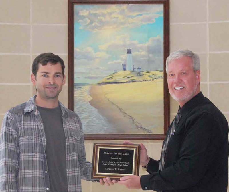 Shown with a plaque to be mounted under the image are Abraxas, left, and Tim Buckmaster, director of personnel for the Cape Henlopen School District. BY STEVEN BILLUPS