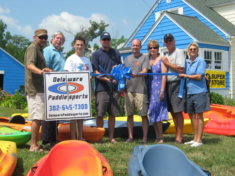 Participating in the ribbon cutting are (l-r) Jason Grden, IMJ Production; Marty Barrett, chamber of commerce; Andrew Keck, Delaware Paddlesports; Brian Kidd, Delaware Paddlesports; John Lester, Delaware Paddlesports; Joy Kidd, chamber of commerce; Rick Kidd; and Katie Handy; Sign*A*Rama. BY SUBMITTED PHOTO