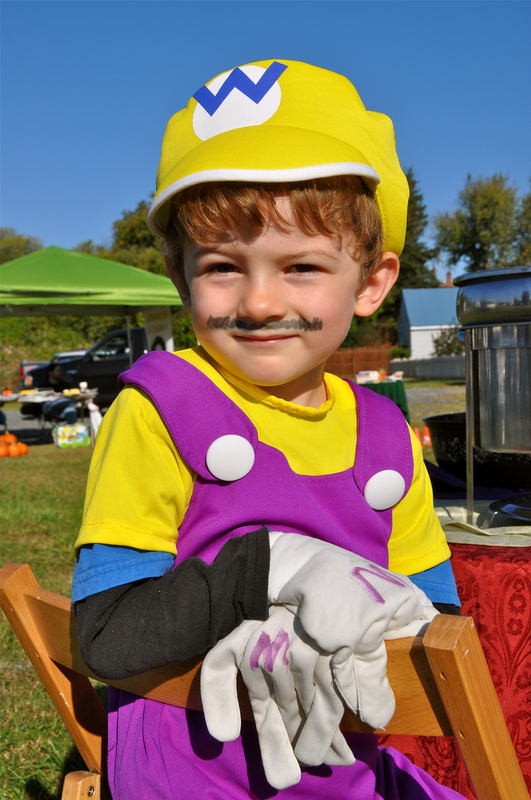 Kevin Stewart, 5, of Milton is ready for Halloween in his Mario Brothers costume. He was helping other family members serve soup at the Po' Boys Creole & Fresh Catch Restaurant booth. BY RON MACARTHUR