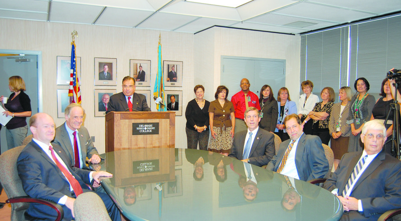 The Delaware congressional delegation joined Del Tech officials in announcing a nearly $5 million grant to help retrain unemployed workers for emerging industry markets. Pictured at the table and podium are (l-r) Sen. Chris Coons, Sen. Tom Carper, Del Tech President Orlando George Jr., Rep. John Carney, Del Tech Board Chairman Mark Stellini and Delaware Department of Labor Secretary John McMahon. SOURCE SUBMITTED