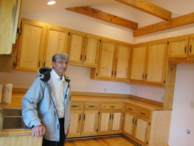 Delaware Wildlands Kent and Sussex Director Pete Martin stands in teh kitchen of the new guest house at the Roman Fisher Farm - east of Gumboro - on the edge of the Great Cypress Swamp. All of the wood in the guest house - including the cabinets (minus the wainscoating ) comes from lumber harvested from the swamp. BY DENNIS FORNEY