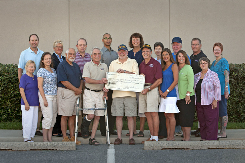 At the check presentation in back (l-r) are Dave Koster, Portraits In The Sand; Linda Wilson, Money Mailer; David Theil, Lokken Investment Group; Dale Dunning, Bank of America; Donna Mulder, Tax & Accounting Advisors LLC; Ellen Feinberg, Smith Feinberg McCartney & Berl LLP; Fred Maahs, Freddy Fix It; Roger Anderson, Parcel Plus; and Peg Hurley, Ancient Art Tattoo. In front are Donna Zetts, Donna's Touch; Bridget Weaver, Weaver's Real Estate Appraisal; Stanley Silverblatt, Silver Electric; Lee Horn, Best Fireplaces; Bill Nixon and David Lawrence, Delaware Seaside Railroad Club; Erin Marsh, Lewes Real Estate; Jeanine O'Donnell, State Farm; and June Betts, The Bank of Delmarva. BY DAVID KOSTER, CPP, PORTRAITS IN THE SAND