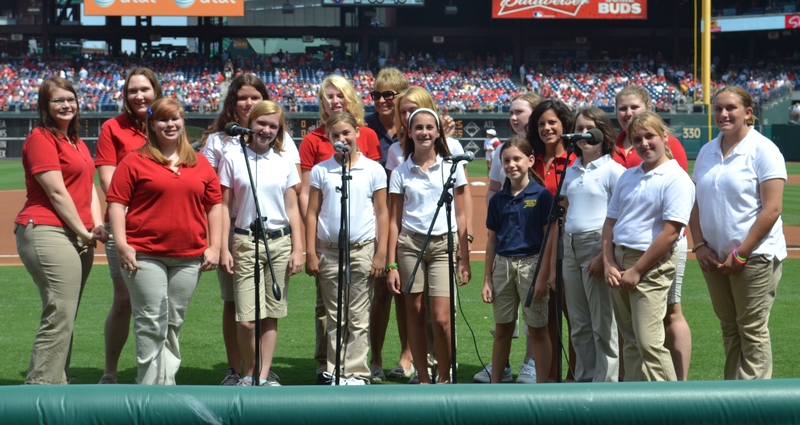 Keenote Chorale members get ready to lift their voices at the Phillies' Aug. 26 game. Shown (back, l-r) are Hannah Wojcielowski, Jessica Smith, Zoe Johnson, Marissa Levis, Jazmyne Marino, Director Debbie Kee, Jessica Creigh (partially obscured), Olivia Esposito, Morgan Kersey and Arianna Sharp. In front are Lauren David, Abigail Hudson, Lexie La Gates, Rachel Esposito, Marissa Hawtof, Claudia Little and Kellie Cortright. SOURCE SUBMITTED