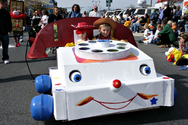 jessie the cowgirl and woody the cowboy ride in the sea witch halloween costume parade in their retro fisher price mobile phone by dave koster