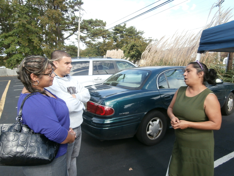 Concerned citizens (l-r) Lesmayra and Samuel Bautista get mortgage advice from DCRAC Executive Director Rashmi Rangan at the open house. BY MOLLY MACMILLAN