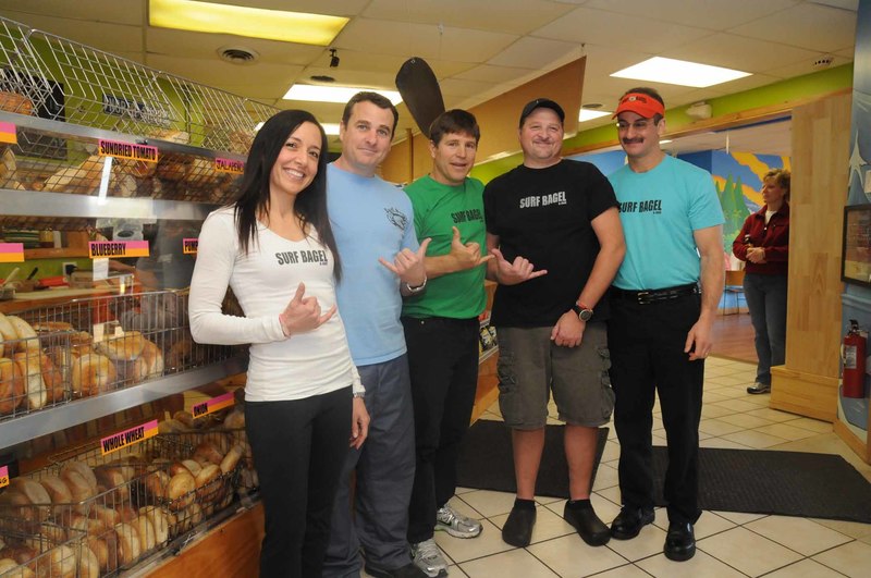 In response to customers' requests, Surf Bagel, located at 17382 Coastal Hwy. in Lewes, recently expanded its hours and menu to include dinner until 8 p.m. Monday through Saturday. The expansion also extended to its restaurant with the addition of a new dining room with vibrant beach themed murals. Shown at the counter are owners (l-r) Liz, Tom and Dave Vitella and managers Paul Garchinsky and John Sapienza. PHOTOS BY STEVEN BILLUPS