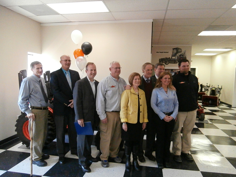 Delaware officials join employees of Burke Equipment to celebrate their first year at the Delmar location. shown in the photo are (l-r) Sussex County Councilman Vance Phillips; Michael Vincent, president of Sussex County Council; Gov. Jack Markell; Burke Equipment owners Mark and Cece Babbitt; U.S.Sen. Tom Carper; Alan Levin, director of the Delaware Economic Development Office; Missy Wagner, chief financial officer, Burke Equipment; and Chris Wagner, general manager, Burke Equipment, Delmar. BY MOLLY MACMILLAN