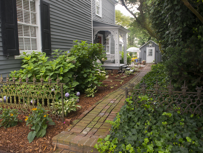 At the Jim Prettyman/Adkins-Draper House, a shaded brick path leads to the garden that overlooks a view of Wagamons Pond. BY DENY HOWETH